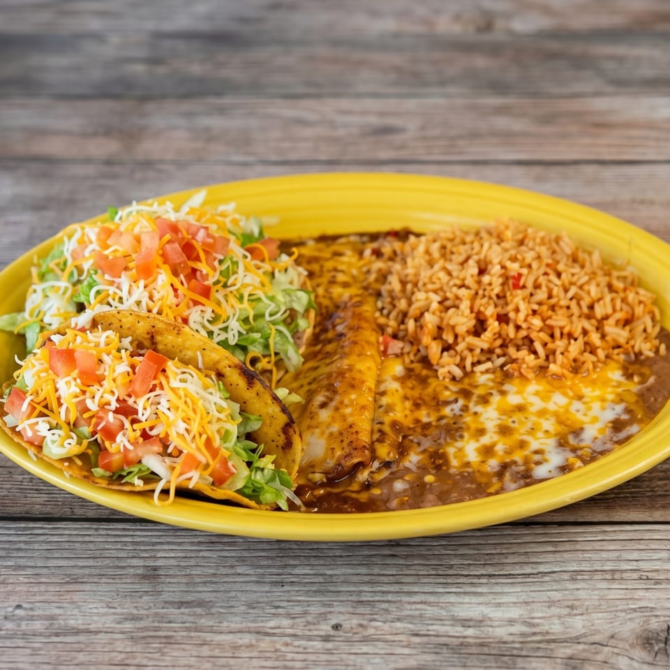A yellow plate holds two tacos, enchiladas, refried beans, and rice on a wooden table.